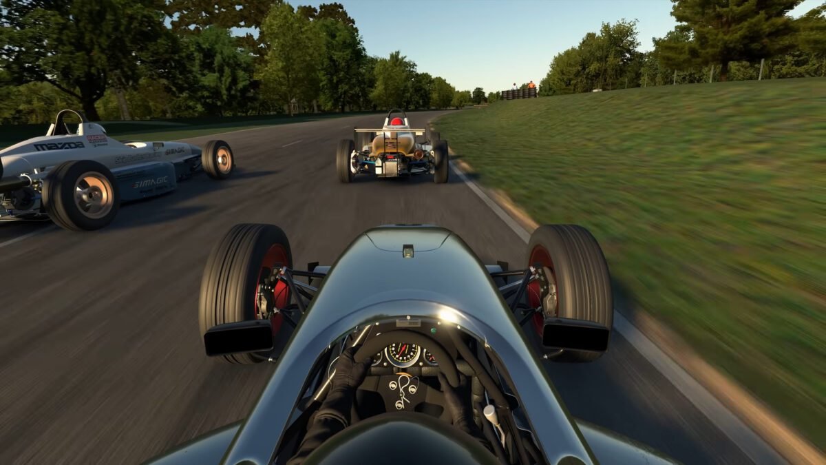 iRacing cockpit view entering a slow corner, showing steering wheel and dashboard
