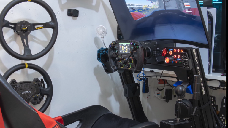 Enclosed sim racing rig setup showing cockpit and steering wheel