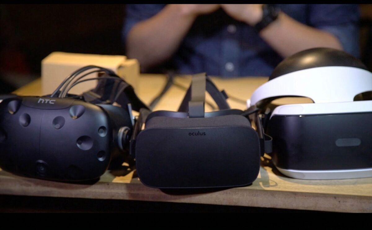 HTC Vive, Oculus, and PlayStation VR headsets laid out for comparison, representing options for PC sim racing